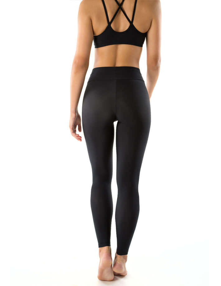 Woman wearing mid rise leggings, full-length yoga leggings in black from the back view, showcasing comfort and style.